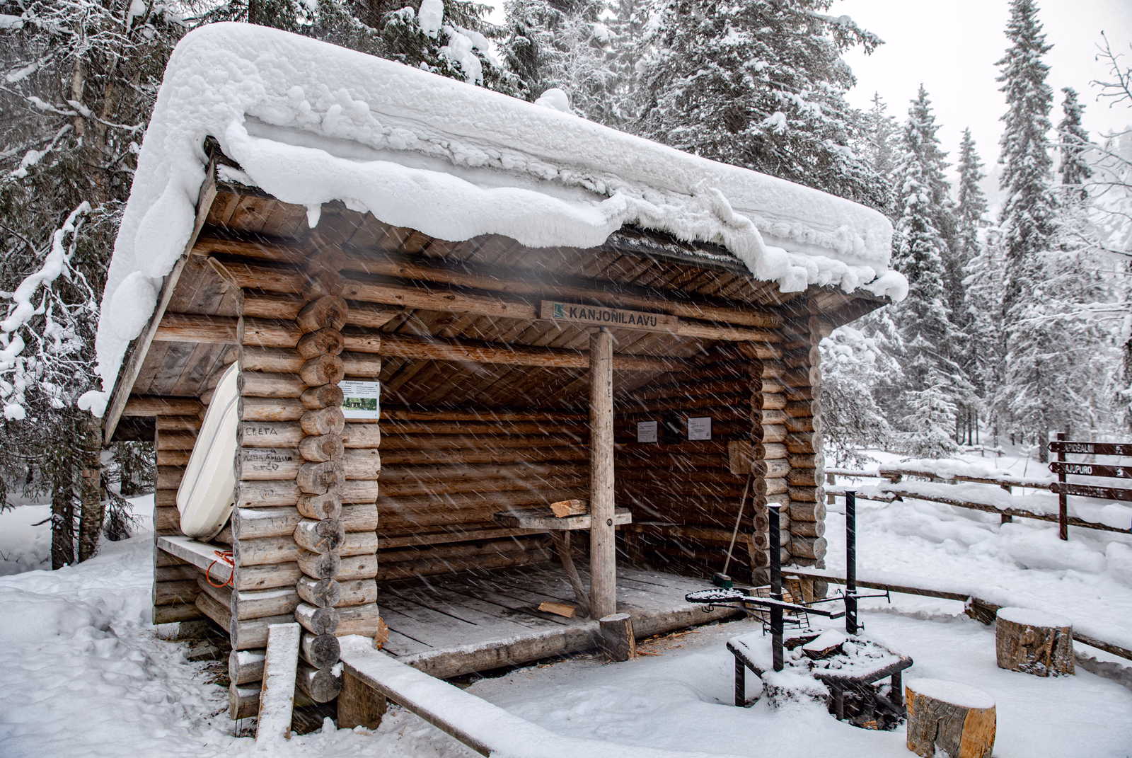 Snow-covered wooden trail shelter in Korouoma canyon
