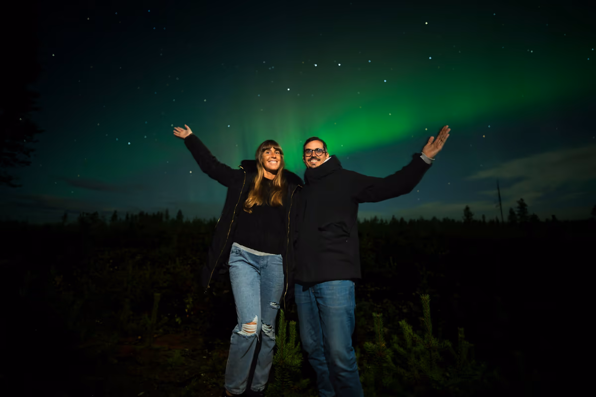 A couple celebrating under the northern lights